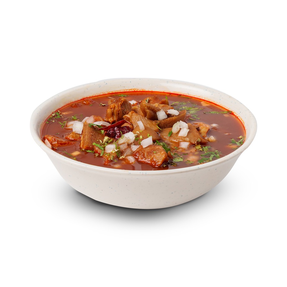 Bowl of menudo with red broth, served with condiments